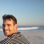 Man looking back at you on the beach