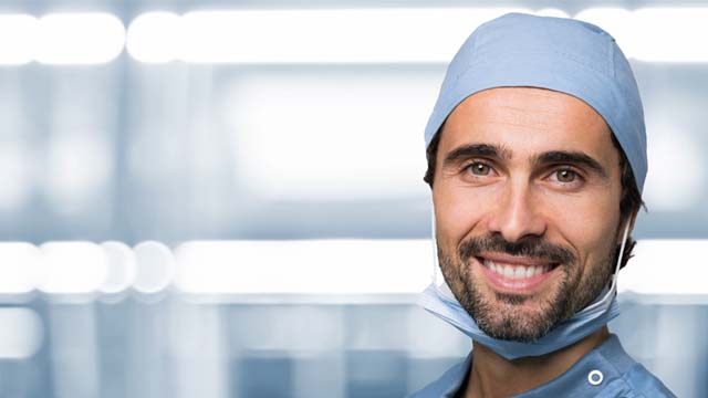 Picture of a hair transplant surgeon smiling at the camera